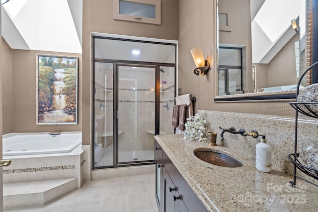 6914 Riesman Ln Unit 95, Charlotte, NC 28210 - full bathroom featuring vanity, a garden tub, a stall shower, and tile patterned floors