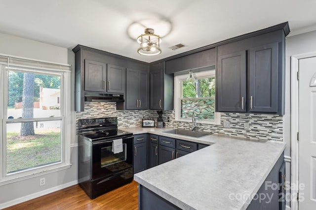 6412 Old Meadow Rd, Charlotte, NC 28227 - kitchen featuring black electric range, a sink, under cabinet range hood, decorative backsplash, and crown molding