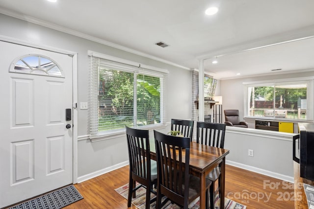 6412 Old Meadow Rd, Charlotte, NC 28227 - dining room featuring ornamental molding, wood finished floors, baseboards, and recessed lighting