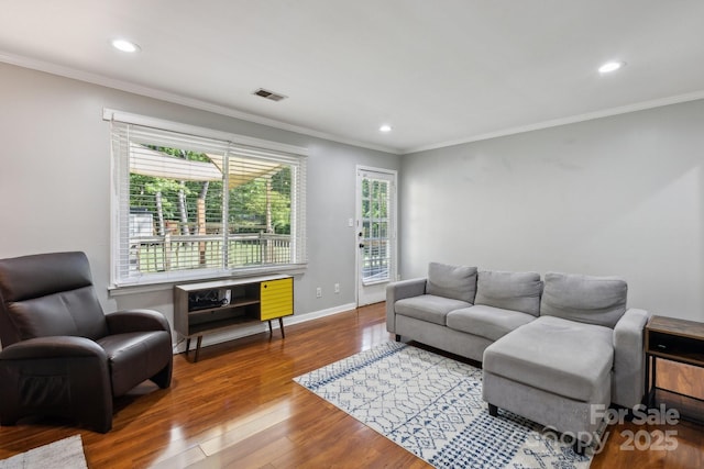 6412 Old Meadow Rd, Charlotte, NC 28227 - living area featuring plenty of natural light, wood finished floors, recessed lighting, crown molding, and baseboards