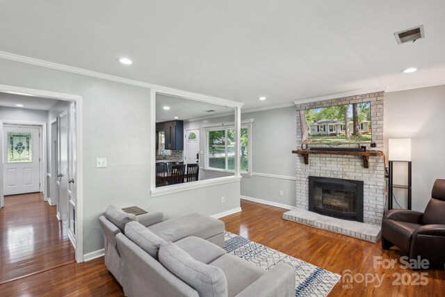 6412 Old Meadow Rd, Charlotte, NC 28227 - living room featuring crown molding, wood finished floors, baseboards, a fireplace, and recessed lighting