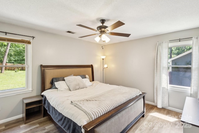 6412 Old Meadow Rd, Charlotte, NC 28227 - bedroom featuring light wood-style flooring, baseboards, ceiling fan, and a textured ceiling