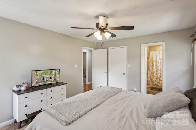 6412 Old Meadow Rd, Charlotte, NC 28227 - bedroom featuring wood finished floors, baseboards, ceiling fan, and connected bathroom