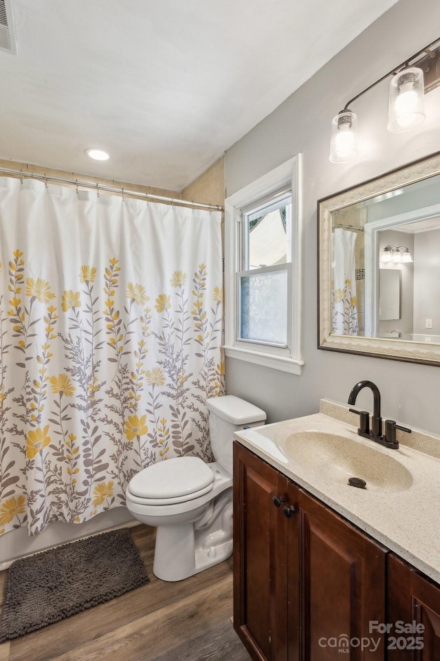 6412 Old Meadow Rd, Charlotte, NC 28227 - full bathroom with wood finished floors, toilet, vanity, and a shower with shower curtain