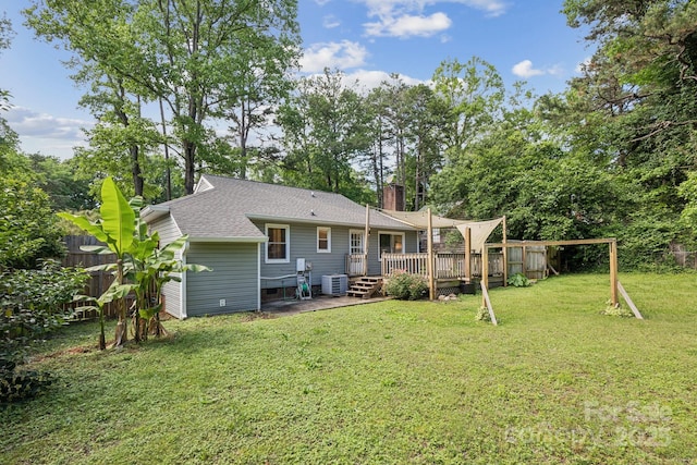 6412 Old Meadow Rd, Charlotte, NC 28227 - rear view of property featuring cooling unit, a deck, a chimney, roof with shingles, and view of wooded area