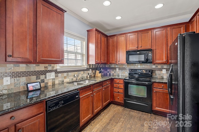 1948 Winpole Ln, Charlotte, NC 28273 - kitchen with dark stone counters, crown molding, a sink, black appliances, and dark wood-style flooring