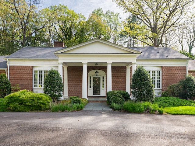 10 Stuyvesant Rd, Asheville, NC 28803 - neoclassical home with a chimney, brick siding, and a porch