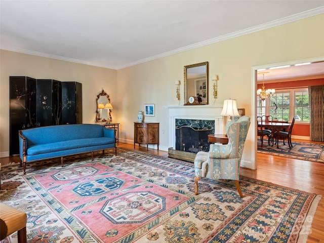 10 Stuyvesant Rd, Asheville, NC 28803 - living area with crown molding, wood finished floors, a premium fireplace, baseboards, and a notable chandelier