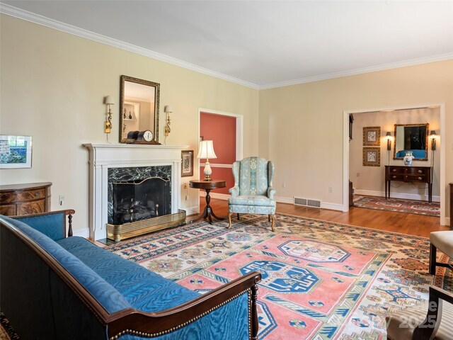 10 Stuyvesant Rd, Asheville, NC 28803 - living room with baseboards, visible vents, wood finished floors, a high end fireplace, and ornamental molding