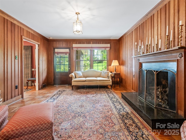10 Stuyvesant Rd, Asheville, NC 28803 - living room featuring wooden walls, baseboards, a fireplace, and ornamental molding