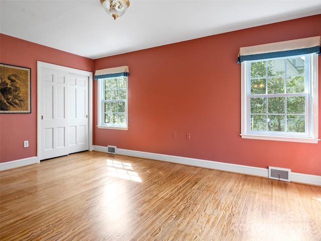 10 Stuyvesant Rd, Asheville, NC 28803 - unfurnished bedroom featuring a closet, wood finished floors, visible vents, and baseboards