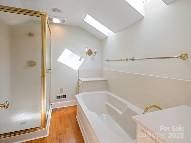 10 Stuyvesant Rd, Asheville, NC 28803 - bathroom featuring a bath, visible vents, a stall shower, and wood finished floors