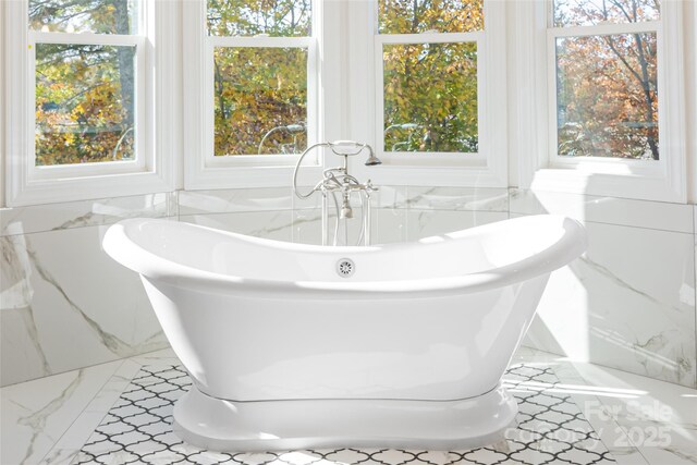 4950 Canterbury Pl, Morganton, NC 28655 - full bathroom featuring marble finish floor, tile walls, a freestanding tub, and a healthy amount of sunlight