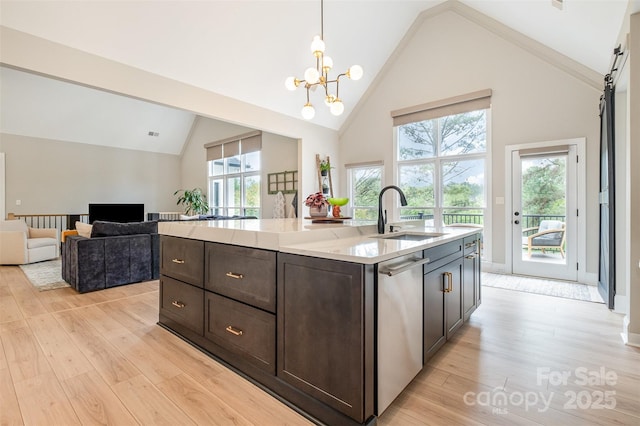 kitchen featuring a sink, stainless steel dishwasher, dark brown cabinetry, and light wood-type flooring
