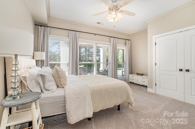 bedroom featuring ornamental molding, carpet flooring, ceiling fan, and visible vents