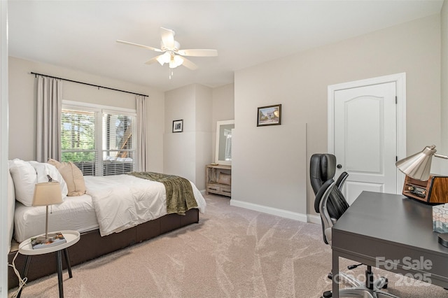 bedroom featuring baseboards, ceiling fan, and light carpet