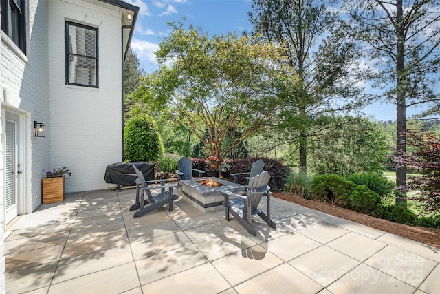 view of patio / terrace with a fire pit and area for grilling