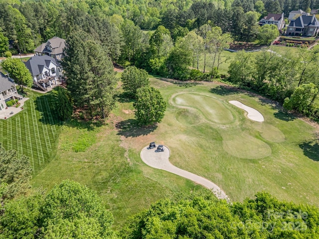 aerial view featuring golf course view and a forest view