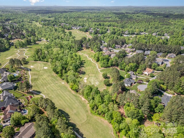 birds eye view of property with a residential view, view of golf course, and a forest view