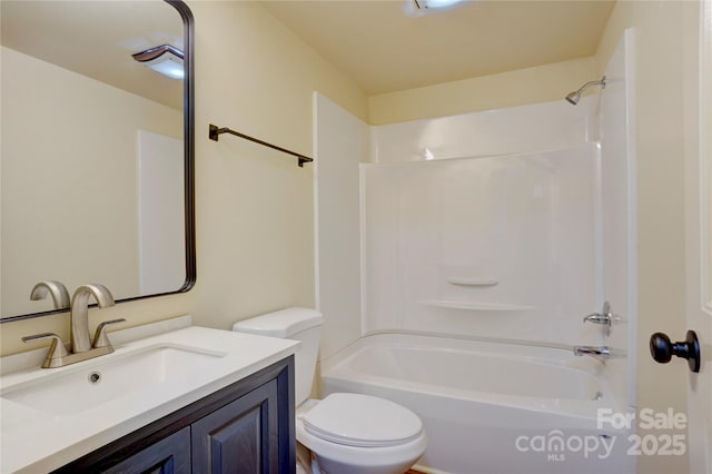 bathroom with toilet, shower / bathing tub combination, and vanity