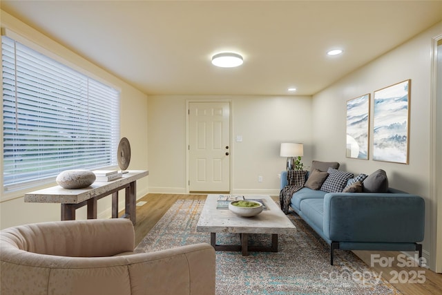 living room with baseboards, recessed lighting, and wood finished floors