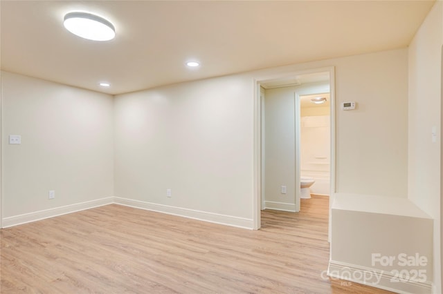 unfurnished room with baseboards, recessed lighting, and light wood-style flooring