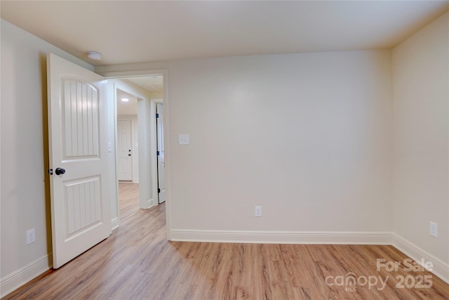 unfurnished room featuring baseboards and light wood-style flooring