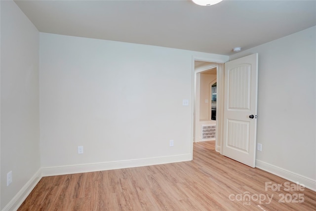 unfurnished room featuring baseboards and wood finished floors