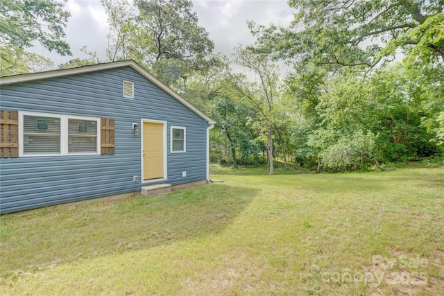 rear view of property featuring a lawn