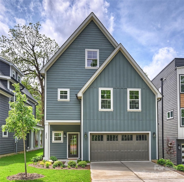 205 Coxe Ave, Charlotte, NC 28208 - view of front of house with a garage, a front lawn, board and batten siding, and driveway
