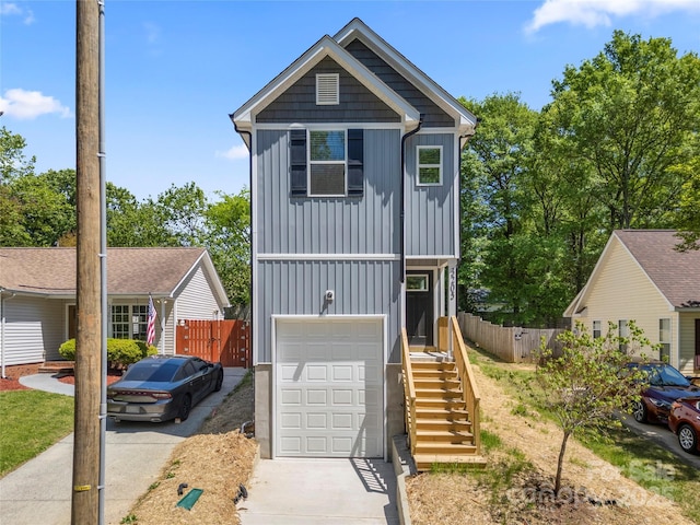 3205 Morning Dr, Charlotte, NC 28208 - view of front of house with a garage, board and batten siding, fence, and concrete driveway