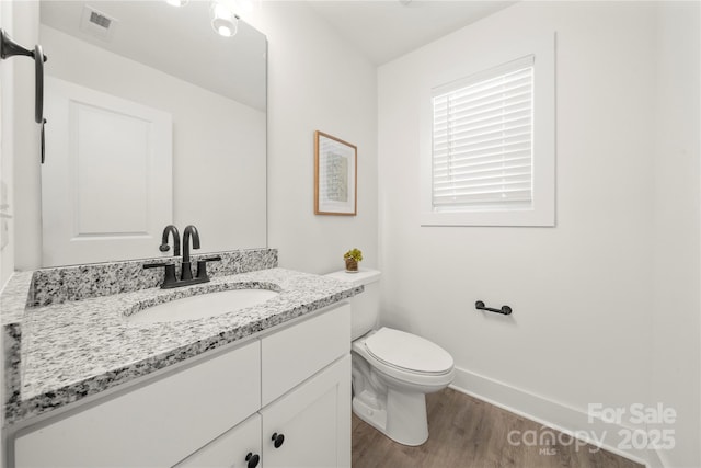 3205 Morning Dr, Charlotte, NC 28208 - bathroom with vanity, toilet, baseboards, wood finished floors, and visible vents