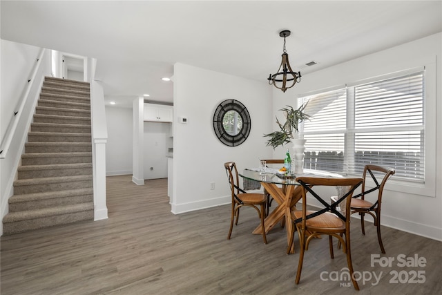 3205 Morning Dr, Charlotte, NC 28208 - dining area featuring baseboards, stairs, visible vents, and light wood-type flooring