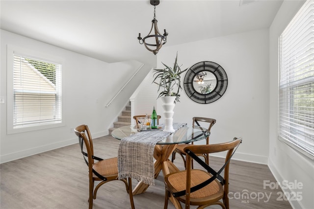 3205 Morning Dr, Charlotte, NC 28208 - dining area with stairs, baseboards, and light wood finished floors