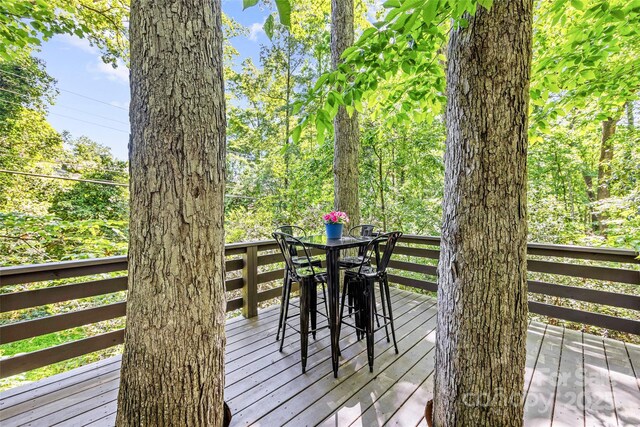 wooden terrace with outdoor dining area