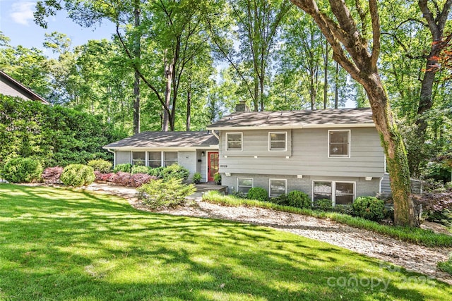 3329 Winnipeg Cir, Charlotte, NC 28210 - tri-level home with a front yard, a chimney, and brick siding