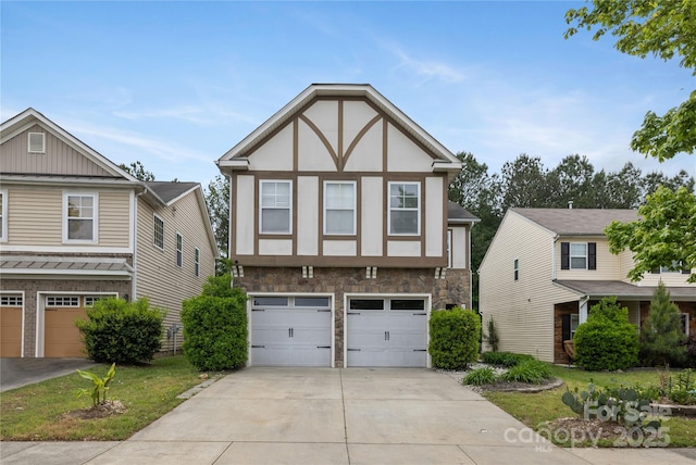 english style home with a garage, driveway, stone siding, and board and batten siding