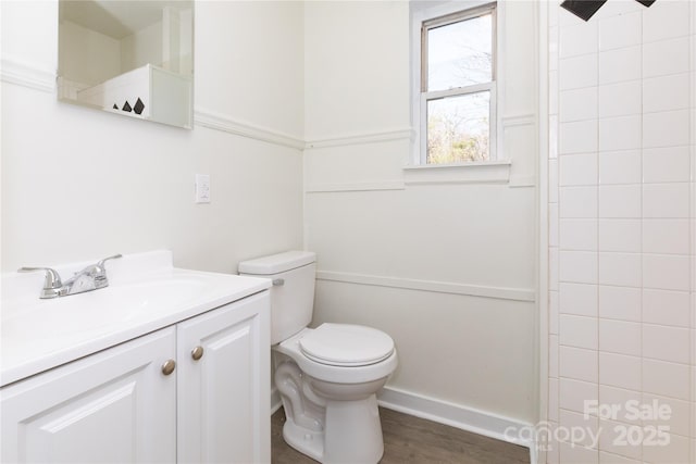 full bathroom with vanity, wood finished floors, toilet, and a shower