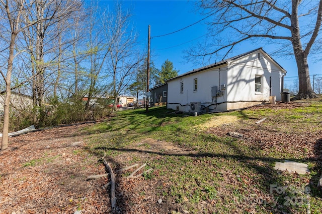 view of side of property with a lawn