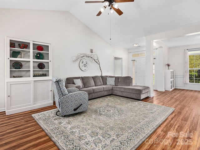 living room featuring wood finished floors, ceiling fan, and vaulted ceiling