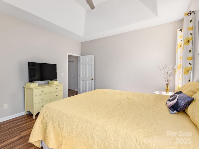 bedroom with dark wood finished floors and baseboards