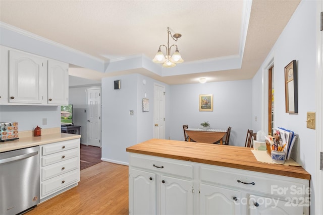 kitchen featuring light wood finished floors, a chandelier, white cabinetry, stainless steel dishwasher, and pendant lighting