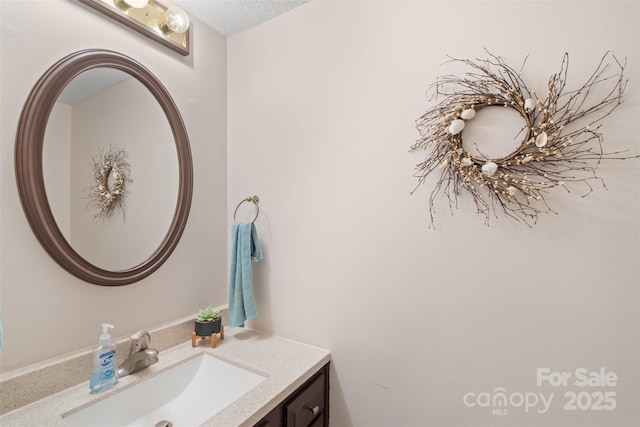 bathroom featuring vanity and a textured ceiling