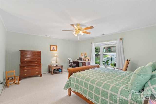 carpeted bedroom with crown molding, ceiling fan, and baseboards