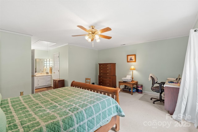 bedroom featuring a ceiling fan, attic access, crown molding, carpet floors, and baseboards
