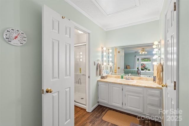 ensuite bathroom with vanity, ensuite bath, wood finished floors, ornamental molding, and a stall shower