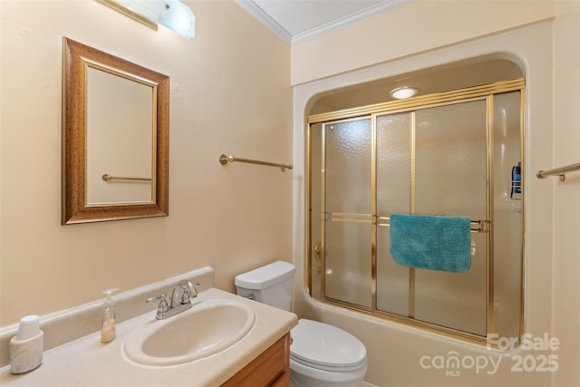 full bath featuring vanity, ornamental molding, enclosed tub / shower combo, and toilet