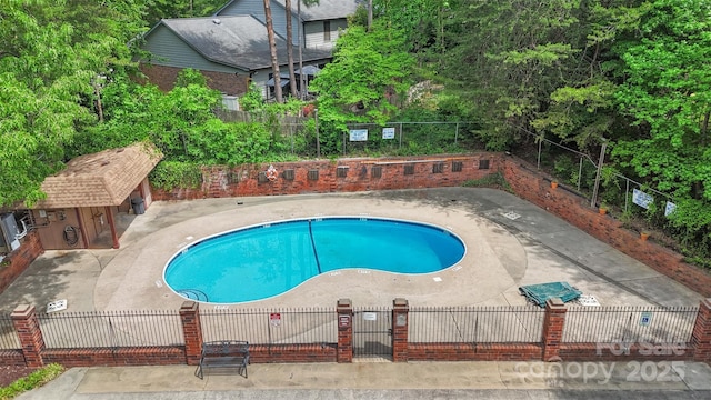 community pool with fence private yard and a patio