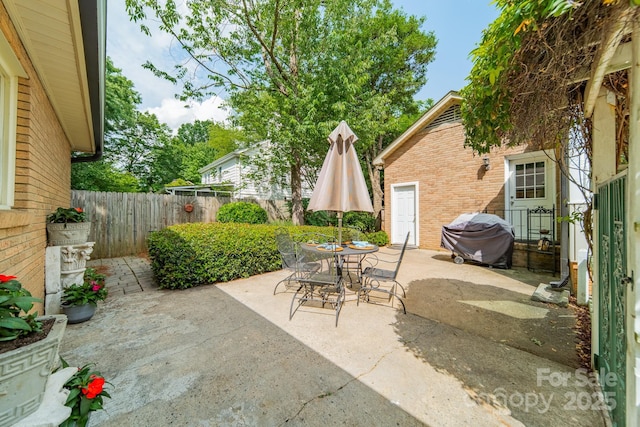 5522 Sharon Rd, Charlotte, NC 28210 - fenced backyard with a grill, a patio area, and outdoor dining space