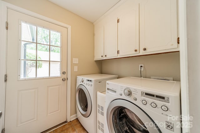 5522 Sharon Rd, Charlotte, NC 28210 - washroom featuring cabinet space, washer and clothes dryer, and light tile patterned floors